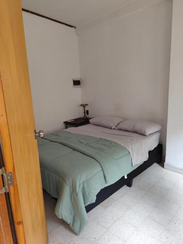 a bedroom with a bed in a white room at Libertador 6 MVD in Montevideo
