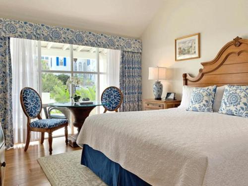 a bedroom with a bed and a table and chairs at Rosedon - Adults Only in Hamilton