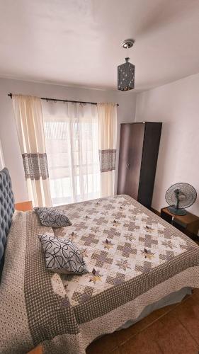 a bedroom with a large bed and a window at Apart-Hotel Katari in Arica