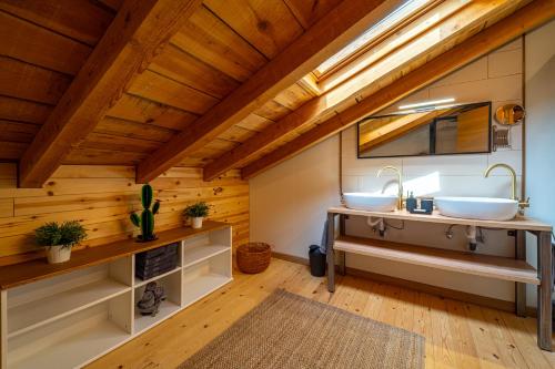 two sinks in a bathroom with wooden ceilings at La Casa de Mi Madre casa rural con jacuzzi in La Parrilla