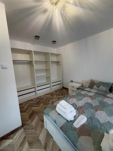 a bedroom with a bed with towels on it at Apartment Draganovi 8A in Kazanlŭk