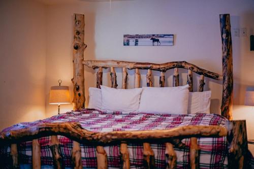 a bedroom with a wooden bed with a wooden headboard at The Loose Moose Lodge #1 At Downtown Grand Lake in Grand Lake