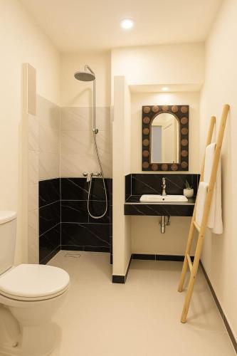 a bathroom with a shower and a toilet and a sink at Dar Salwa in Aït Benhaddou