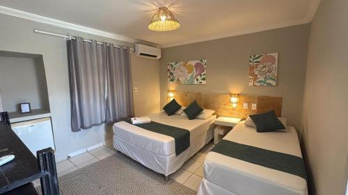 Ένα ή περισσότερα κρεβάτια σε δωμάτιο στο Pousada Hippopotamus Jeri