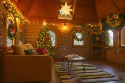 a living room with a christmas tree and a couch at River House in Belgrade