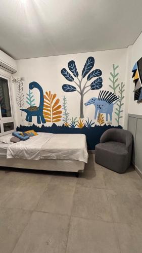 a bedroom with a bed with a mural on the wall at Eliseo Chalet in Yerba Buena