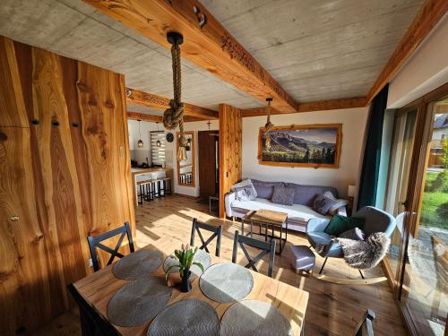 a living room with a couch and a table at Holne domki in Poronin
