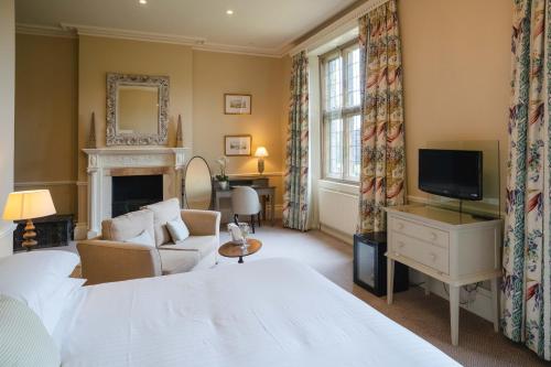 a hotel room with a bed and a tv at Gisborough Hall Hotel in Guisborough