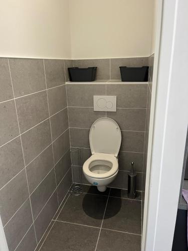 a small bathroom with a toilet in a stall at Ampuis centre - Appartement indépendant in Ampuis