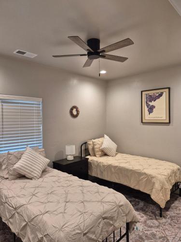 a bedroom with two beds and a ceiling fan at Bluff 11 Professional Housing in Delta