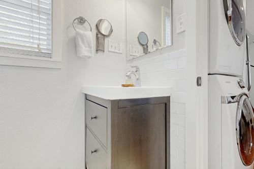 a bathroom with a sink and a mirror at Hyde Park Carriage House in Austin
