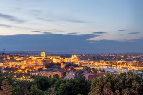 a view of the city of vienna at night at Tranquil Hideaway on Gellért Hill with Parking in Budapest