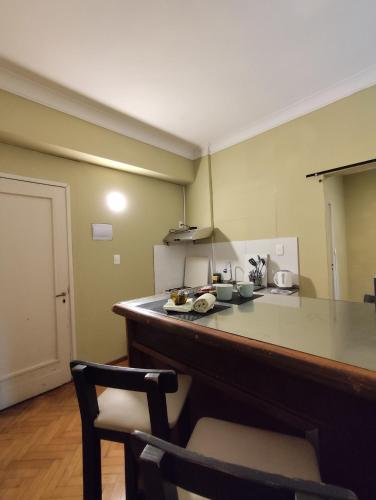 a kitchen with a counter and a chair in a room at Libertador 8 MVD in Montevideo