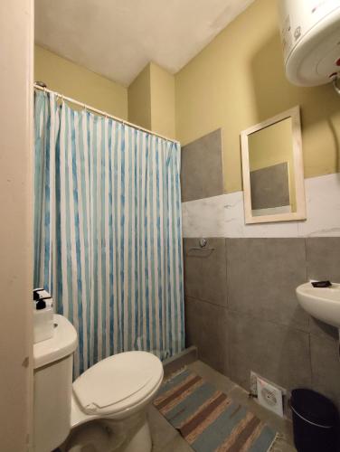 a bathroom with a toilet and a sink at Libertador 8 MVD in Montevideo