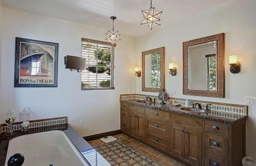 a bathroom with a tub and two sinks and a bath tub at Ocean View Villa in Santa Barbara
