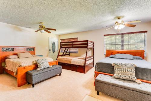 a bedroom with two beds and a bunk bed at Suwannee River Retreat Pet Friendly, Private Dock in Branford