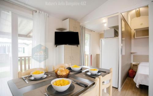 a kitchen with a table with bowls of fruit on it at Casa Nature's Avlis Bungalow 4XZ in Pataias