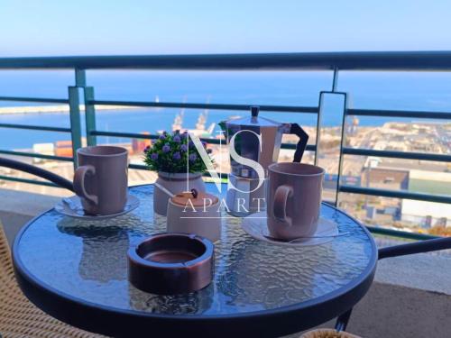 a table with two cups and a tea pot on it at NORTH SUITE - Vista al Mar Centricos Dptos Frente al Mall in Antofagasta
