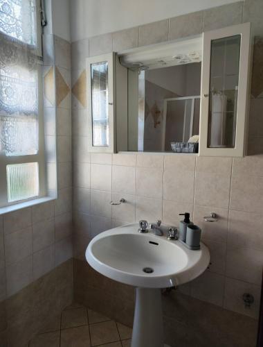 a bathroom with a white sink and a mirror at Cà Giaculn in Muriaglio