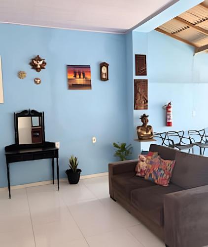 ein Wohnzimmer mit einer Couch und einem Klavier in der Unterkunft Residência j&m in São Luís