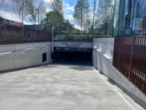 a large parking garage with a sign on it at Modern 2 Bed Penthouse with Stunning views in Manchester City Center in Manchester