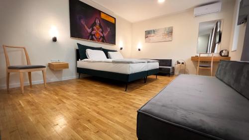 a bedroom with a bed and a couch at Eda7 Boutique Rooms in Sarajevo
