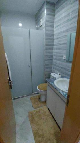a bathroom with a toilet and a sink at Pleasant 3-bedroom in Praia City in Praia