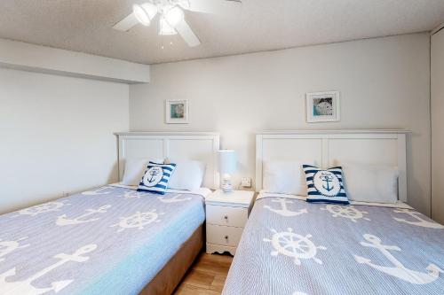 a bedroom with two beds with blue and white pillows at Pyramid 9G in Ocean City