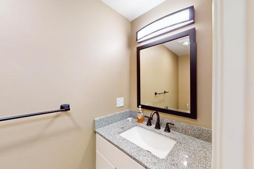 a bathroom with a sink and a mirror at Summer Cape Escape in Dennis Port