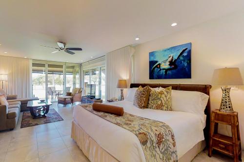 a bedroom with a large bed and a living room at Maui Eldorado Resort G111 in Kaanapali