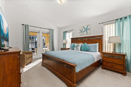 a bedroom with a bed and a television in it at 373 - Stunning 4 Bedroom Villa with own Private South East Facing Pool in Orlando