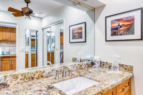 a kitchen with a sink and a ceiling fan at Maui Eldorado Resort E205 in Kaanapali