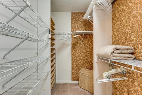 a walk in closet with metal shelves and a shower at 2 Mi to KSU Family Home with Games, Near Parks in Kennesaw