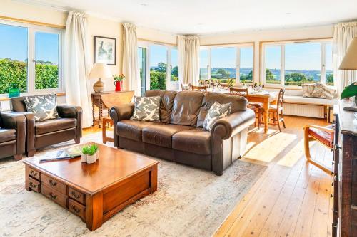 a living room with a couch and a table at Peaceful cottage with views - Fairview Cottage in Mylor Bridge