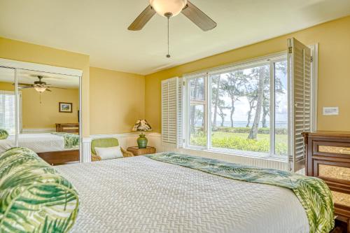 a bedroom with a bed and a large window at Pono Kai Resort D101 in Waipouli