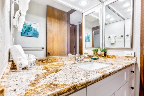 a bathroom with a sink and a mirror at Papakea Resort E203 in Honokowai