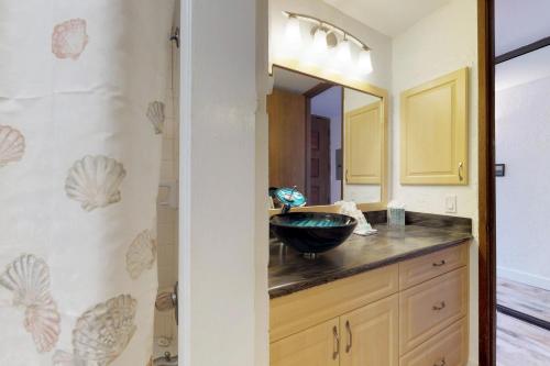 a bathroom with a sink and a mirror at Papakea Resort C204 in Honokowai
