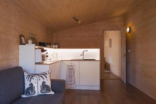 a living room with a couch and a kitchen at Kanali Guest House - Sauna Included - Free Parking in Pärnu