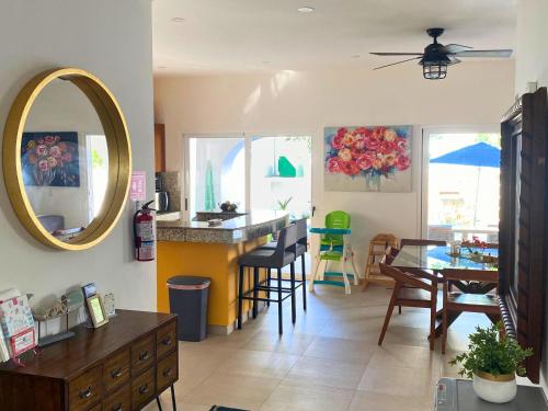 a living room with a table and a mirror at Casa Sienna Lia Spacious House in Isla Mujeres