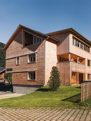 a large brick building with at tinnes apartments in Schoppernau