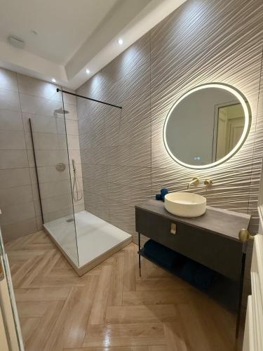 a bathroom with a sink and a mirror at Vue Mer Panoramique - Appartement d'Exception in Wimereux