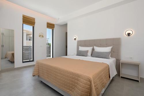 a bedroom with a large bed and a balcony at Villa Marco in Zakynthos Town