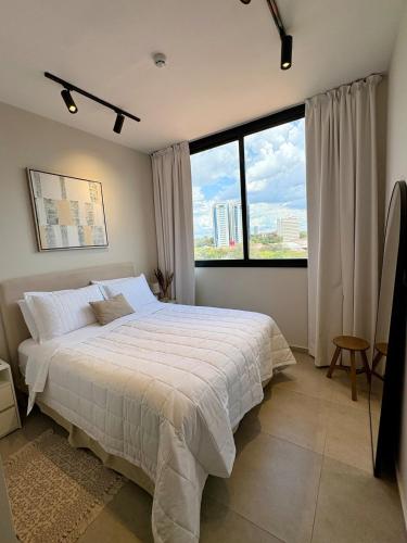 a bedroom with a large bed and a large window at Firenze 5G - Vivelite in Caña de Castilla
