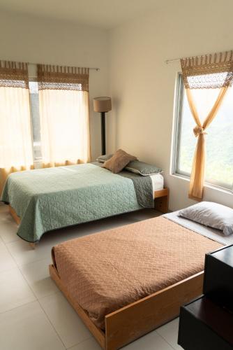 a bedroom with two beds and a window at Terraza Lotelazo in Guadalajara