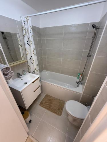 a bathroom with a tub and a toilet and a sink at Le Cocon in Nice