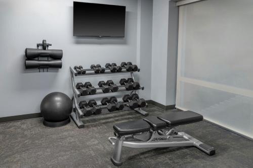 a gym with a bench and a tv on a wall at Fairfield Inn by Marriott New York Manhattan/Financial District in New York