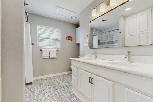 a bathroom with two sinks and a mirror at The Lazy Bay in Rockport