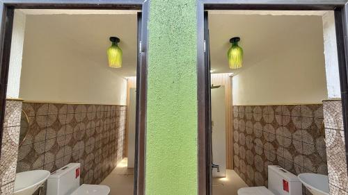 a bathroom with two mirrors and three toilets at Rosa del Sol - Entire Private Villa with Pool in Calasiao
