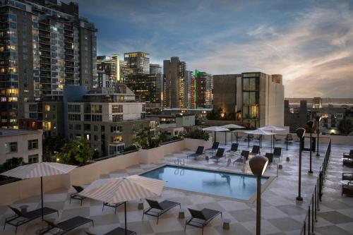 une terrasse sur le toit avec une piscine, des chaises et des parasols dans l'établissement Courtyard by Marriott San Diego Downtown Little Italy, à San Diego