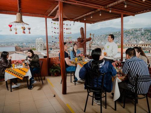 a group of people sitting at tables in a restaurant at Hotel San Francisco de Paula Ayacucho in Ayacucho